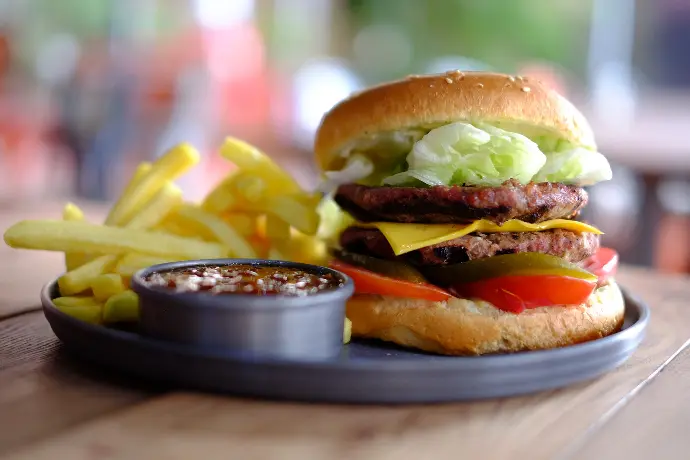 hamburger and fries with dip on tray